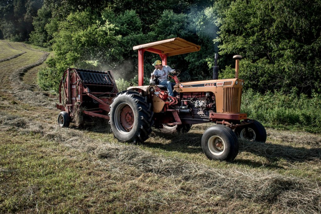 Sam Duran bales hay on Fathers Day. Both he and his twin brother Dan work day jobs to keep their multi-generational farm going. When time allows, they attend citizen and township meetings where permitting and health issues related to the proposed plants are discussed.